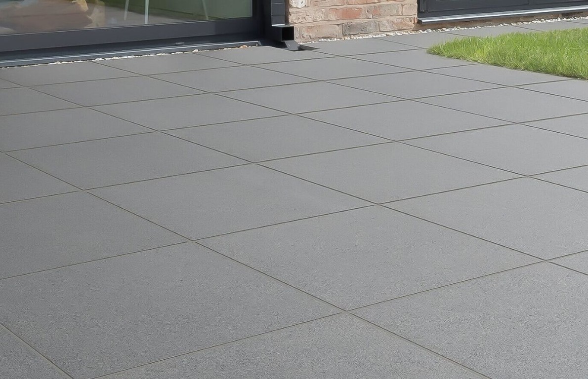 Modern concrete pool deck with large tile pattern and clean lines